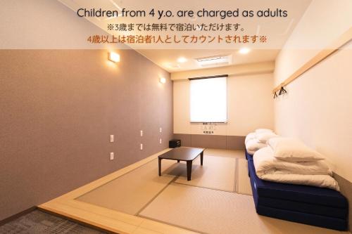 a room with a couch and a table at Wild Cherry Blossom-HOSTEL,TOKYO KOGANEI- in Koganei