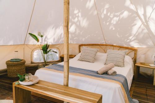 a bedroom with a bed in a tent at Parada Beach Camp in El Nido