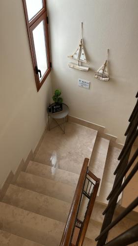 an empty room with stairs and a window and a table at San Pietro Otranto in Otranto