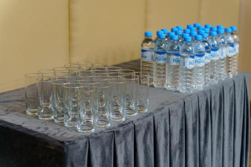 a table with glasses and bottles of water on it at Jannat Resort Osh in Osh