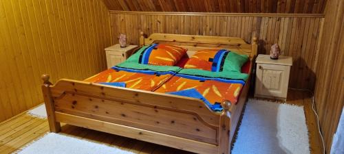 a bedroom with a wooden bed in a room at Villa Jare I in Nyíregyháza