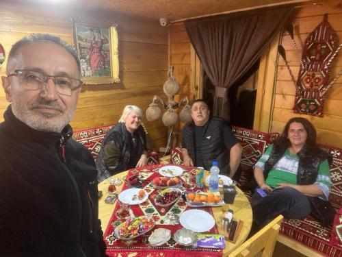 a group of people sitting around a table at Etno meandri Uvca in Sjenica