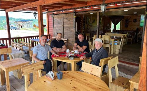 a group of men sitting at a table at Etno meandri Uvca in Sjenica