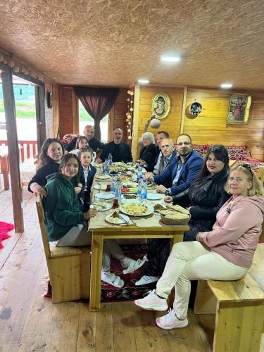 a group of people sitting at a dinner table at Etno meandri Uvca in Sjenica