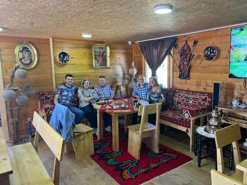 a group of people sitting around a table in a room at Etno meandri Uvca in Sjenica