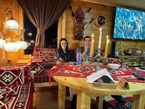 a man and a woman sitting at a table at Etno meandri Uvca in Sjenica