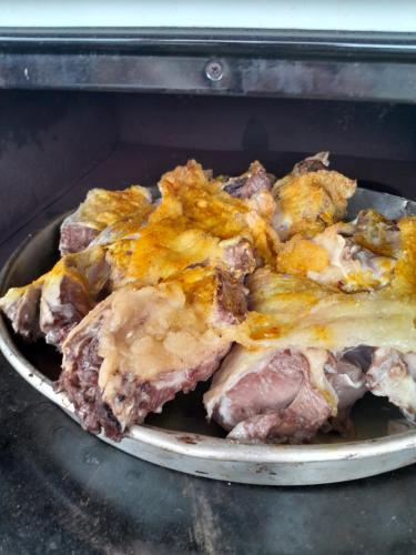 a close up of a pan of food in an oven at Etno meandri Uvca in Sjenica
