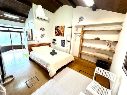 a bedroom with a bed and a desk in it at Kyoto G in Kyoto