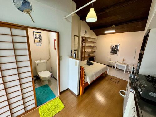a bedroom with a bed and a toilet in a room at Kyoto G in Kyoto