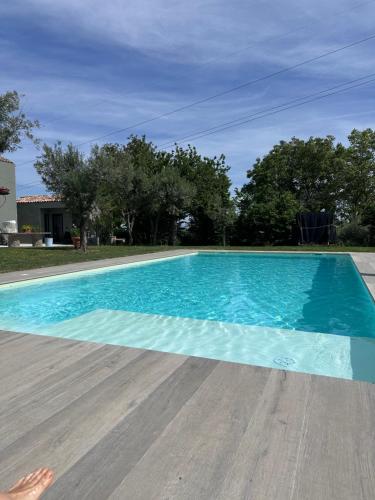 a swimming pool with blue water in a yard at Borghetto Sant’Angelo in Soriano nel Cimino