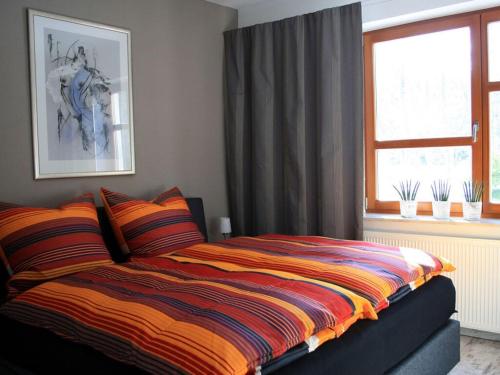 a bedroom with a bed with a colorful blanket at Living Lust 2 in Malchow in Malchow