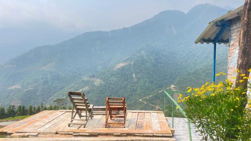 two chairs sitting on a deck with a view of a mountain at My's Homestay sapa in Sa Pa