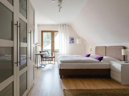 a bedroom with a bed and a table and chairs at Country House Mettenberg in Eslohe