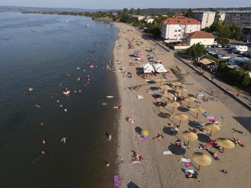 an overhead view of a beach with people and umbrellas at Villa Mina Kladovo, 5-Bedroom Villa with Pool for up to 12 People in Kladovo