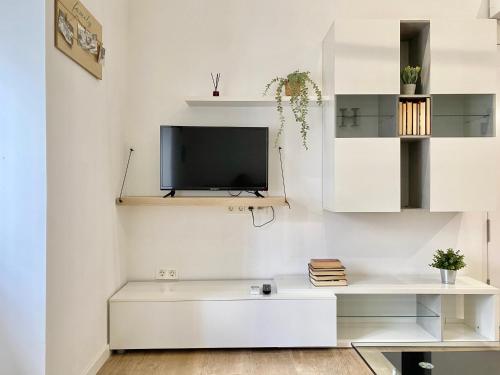 Televízia a/alebo spoločenská miestnosť v ubytovaní Apartamento Villa María II