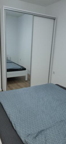 a bedroom with a bed and a mirror at Comfort in Kiseljak