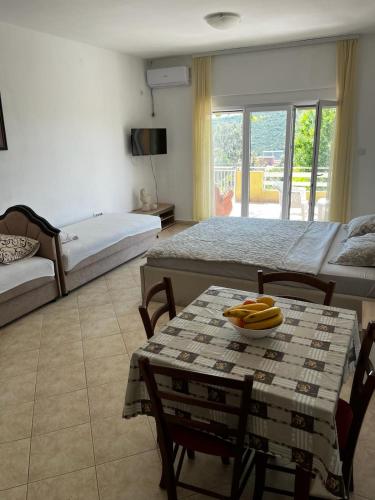 Cette chambre comprend 2 lits et une table avec des bananes. dans l'établissement Apartman Perić, à Bigovo