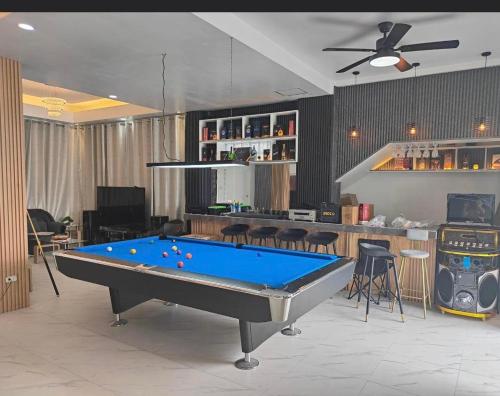 a living room with a pool table and a bar at Clarin's Beach in Pagbilao
