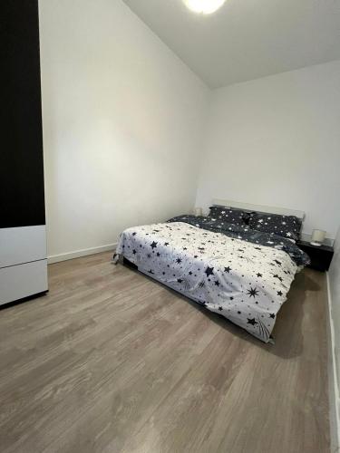 Schlafzimmer mit einem Bett und Holzboden in der Unterkunft Universitatii Rooms in Oradea