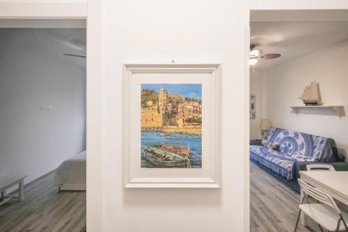 a painting on a wall in a room with a bed at A casa di Alberta in Deiva Marina