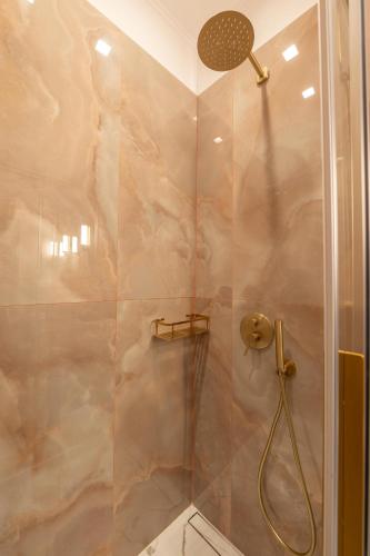 a shower with a glass door in a bathroom at L Suites The Writer's House in Gythio