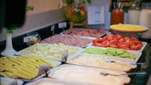 a buffet of different types of food on a table at New Wave Apart-Hotel in Batumi