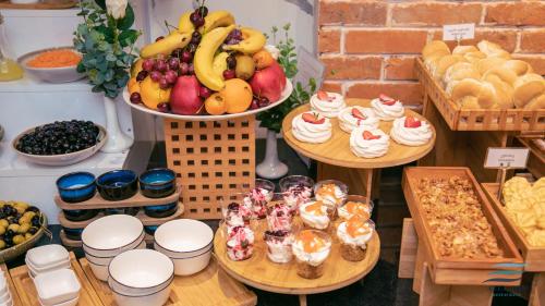 a display of fruit and cakes and other desserts on tables at New Wave Apart-Hotel in Batumi
