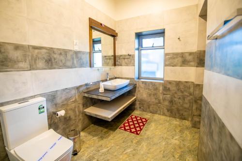 a bathroom with a sink and a toilet at Grand Argyle Resort in Hatton