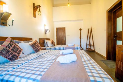 a bedroom with two beds with blue and white sheets at Grand Argyle Resort in Hatton