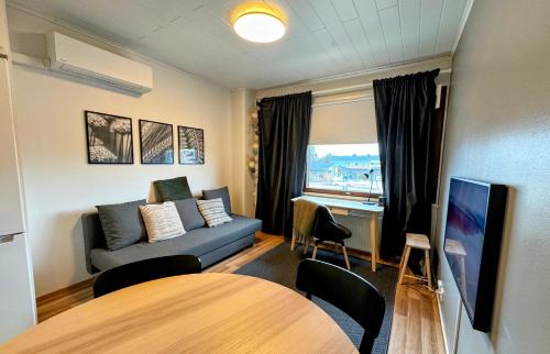 a living room with a couch and a table at Pine Sky Apartments in Ivalo