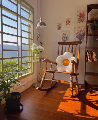 a teddy bear sitting in a chair in a room with a window at Góc sân và Khoảng trời 2 - Đặng Thái Thân (phòng lẻ) in Xuan An