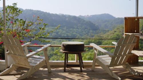 two chairs and a table on a balcony with a view at Góc sân và Khoảng trời 2 - Đặng Thái Thân (phòng lẻ) in Xuan An