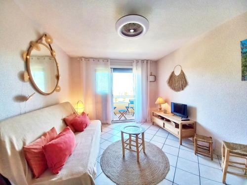 un salon avec un canapé et une télévision dans l'établissement Le Sémaphore, les plages à pied, à Saint-Raphaël