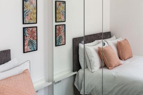a bedroom with a bed and a mirror at Stylish Apartment w/ Private Garden - Dog Friendly in Newport