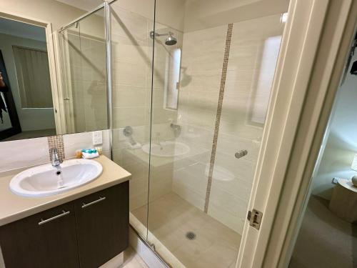 a bathroom with a shower and a sink at South Bunbury Holiday Home in Carey Park
