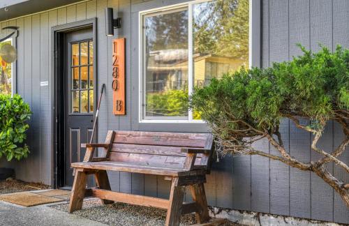 a wooden bench sitting in front of a house at Zen Haus Garden Retreat, prime location, Luxe amenities in Eugene