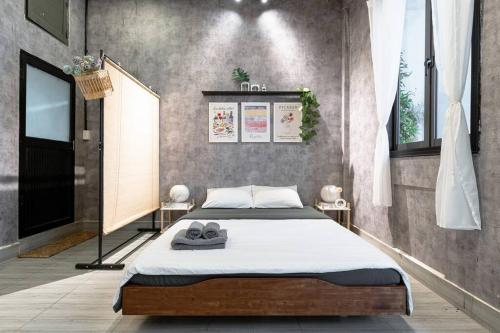 a bedroom with a bed with shoes on it at 2 Bedroom Industrial Apartment in Central Saigon in Ho Chi Minh City