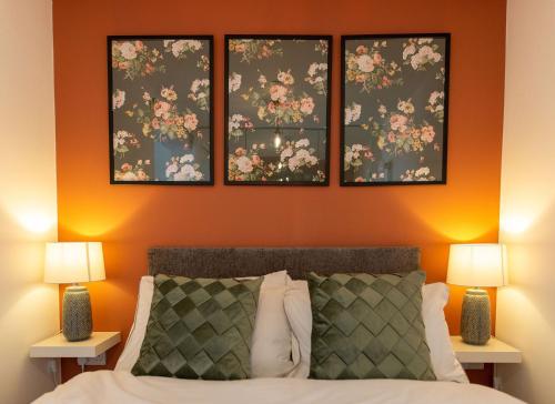 una camera da letto con tre immagini appese al muro sopra un letto di Stylish Studio Apartment with Peloton a Newport
