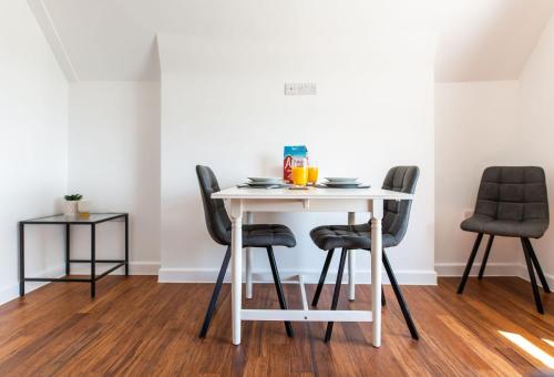 a white table and chairs with drinks on it at Stylish Loft Apartment with View in Newport