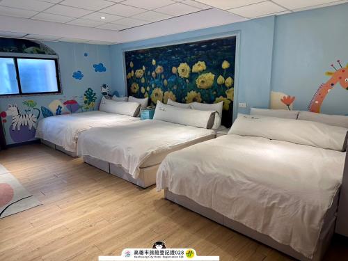 a bedroom with two beds and a painting on the wall at ArtHome藝宿家客棧 in Kaohsiung