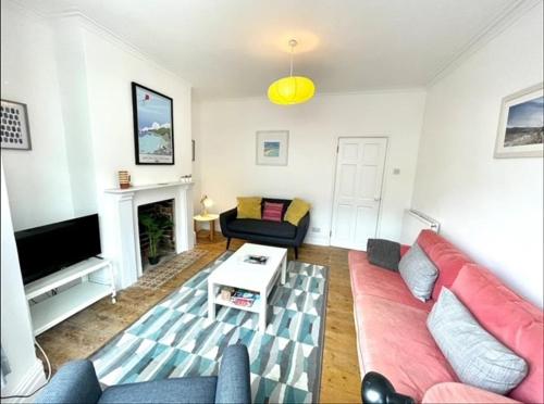 a living room with a couch and a fireplace at *Family Home in Mumbles. Close to the Beach* in The Mumbles