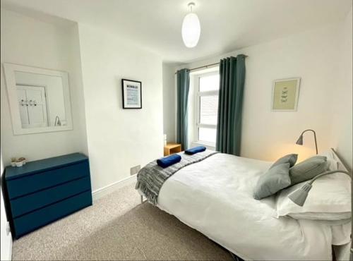 a bedroom with a large bed and a window at *Family Home in Mumbles. Close to the Beach* in The Mumbles