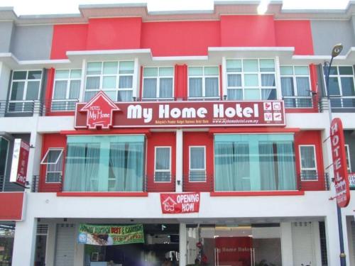 a red and white building with a home hotel at V Hotel Sri Gombak (Previously MyHome Hotel) in Batu Caves