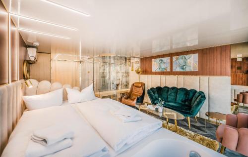 a bedroom with a large white bed and chairs at Hausboot Relax in Sagard