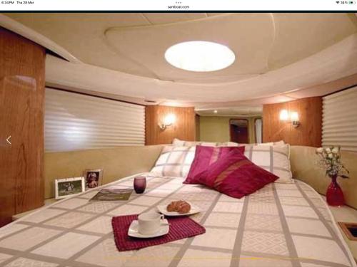 ein Wohnzimmer mit einem großen Bett mit rosa Kissen in der Unterkunft Karma boat cruises in Lagos