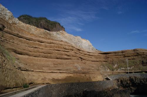 a view of a rock cliff with a road at Hotel Costa Linda in Porto da Cruz