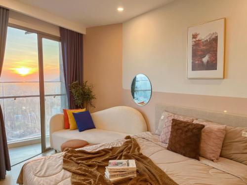 a living room with a couch and a window at The Song Luxury Condotel Vung Tau - Xuân's Homestay in Vung Tau