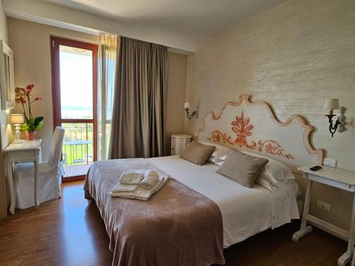 バルドリーノにあるB&B Corte Frisonaiの大きなベッドと窓が備わるホテルルームです。