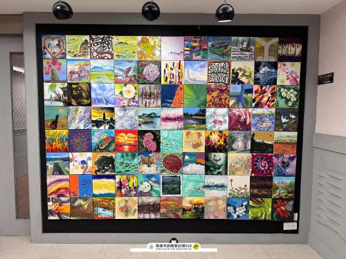 a large collage of pictures on a wall at ArtHome藝宿家客棧 in Kaohsiung