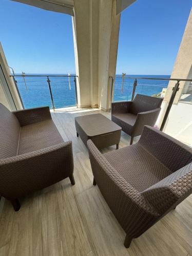 a room with chairs and a view of the ocean at Paradise beachfront view 1 in Bar